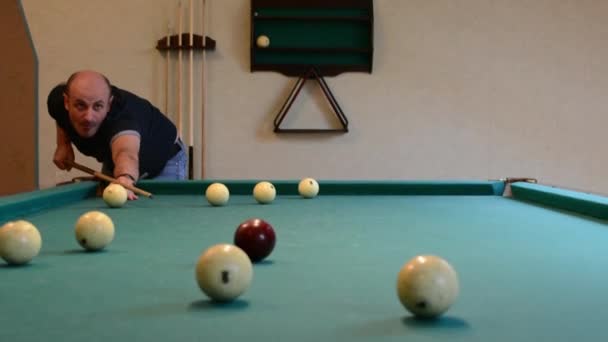 Man in billiards shoots at balls — Stock Video