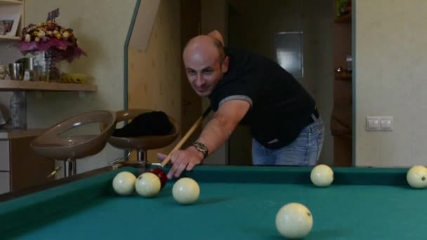 Man in billiards shoots at balls — Stock Video