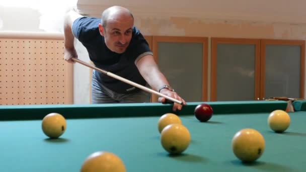 Man in billiards shoots at balls — Stock Video