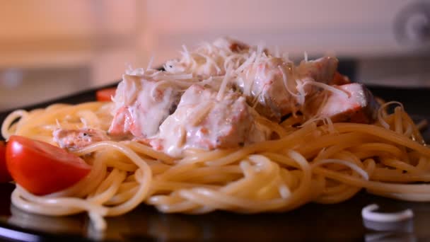 Putting parmesan cheese on spaghetti — Stock Video