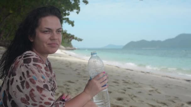 Girl Sits Wild Beach Drink Water — Stock Video