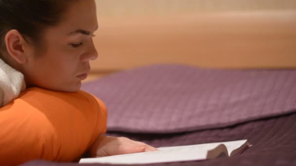 Κορίτσι Διαβάζοντας Ένα Βιβλίο Ξαπλωμένη Στο Κρεβάτι — Αρχείο Βίντεο