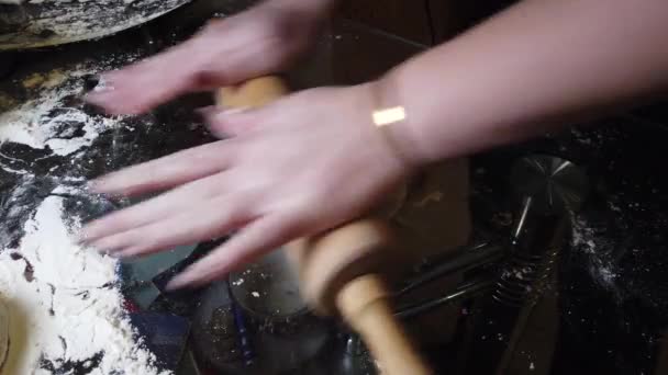 餃子を作るための薄いケーキで台所のテーブルの上にローリングピンで生地をロールアウト — ストック動画