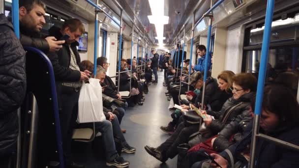 MOSCÚ, RUSIA - 12 DE DICIEMBRE DE 2019: Personas en el vagón del metro. Metro de Moscú. Los pasajeros se sientan en lugares con diferentes actividades . — Vídeos de Stock
