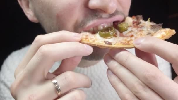 Close Man Eats Pizza Black Background — Stockvideo