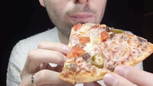 Close Man Eats Pizza Black Background — Stockvideo