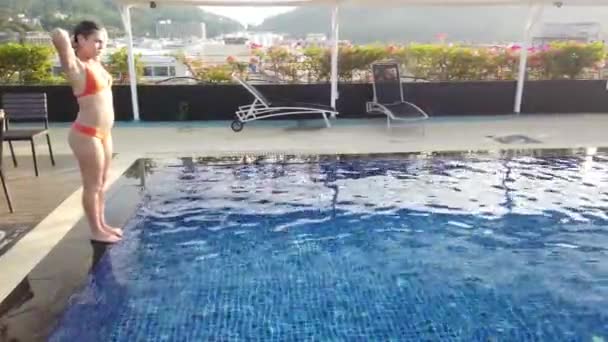 Girl Brunette Swims Blue Pool — Stock Video