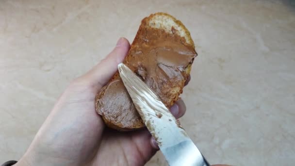 Slow Motion Man Spreading Chocolate Nut Butter Ciabatta Slice — Stock Video