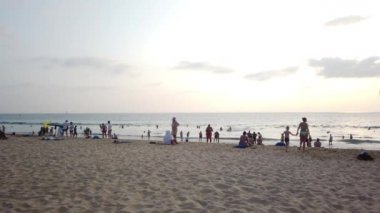 13 Mart 2020, KARON BEACH, PHUKET, THAILAND: Güneşli bir günde güneşin altında güneşlenen ve yüzen sayısız turistin bulunduğu tropik plaj.