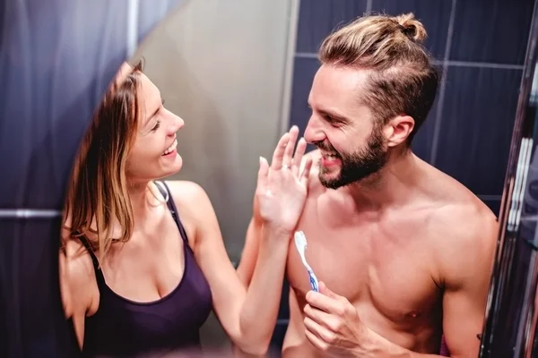 Couple brushing teeth and having fun — Stock Photo, Image