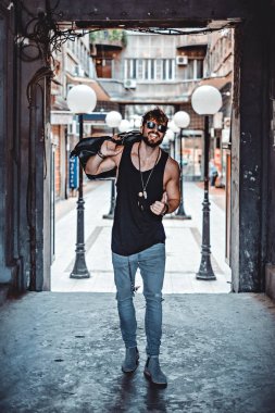 Omuz çantası taşıyan ve başparmak dayanabiliyor yakışıklı adam