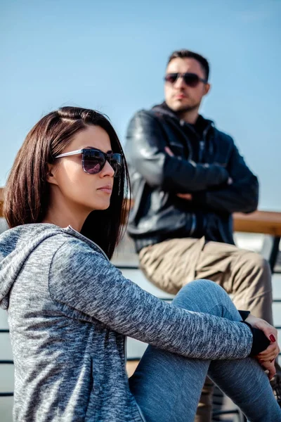 Angry couple sitting outside not looking at each other — Stock Photo, Image