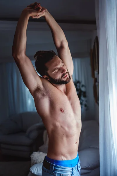 Shirtless man morning routine by the window — Stock Photo, Image