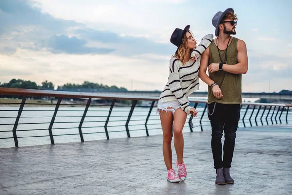 Man standing and looking annoyed while girl teases him — Stock Photo, Image