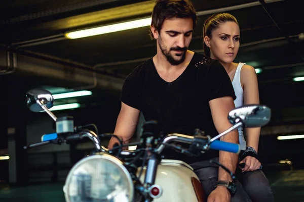 Sad and angry couple sitting on a motorcycle — Stock Photo, Image