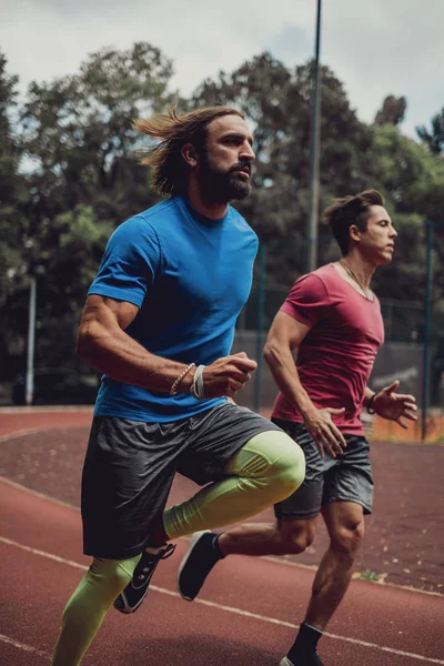 Two athletic man running outdoor