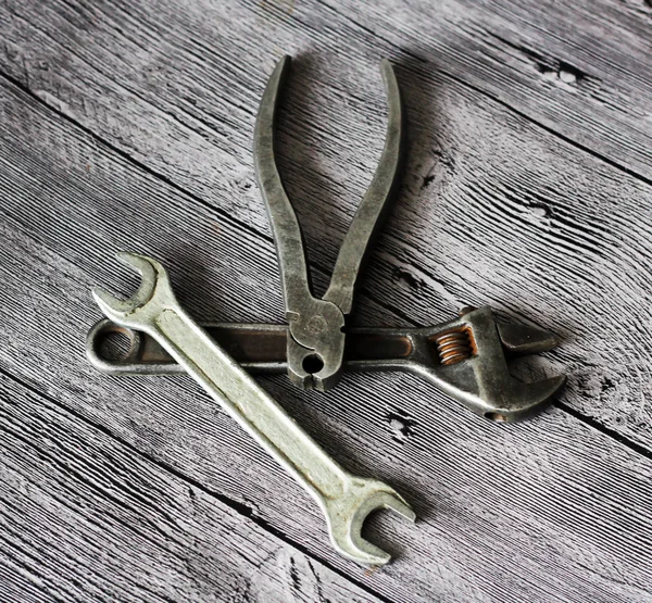 Tools for repairs on a wooden background