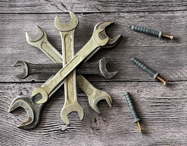 Tools for repairs on a wooden background