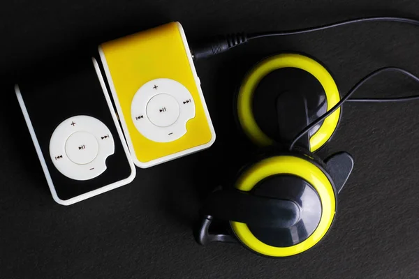 Yellow music player and beautiful overhead headphones — Stock Photo, Image