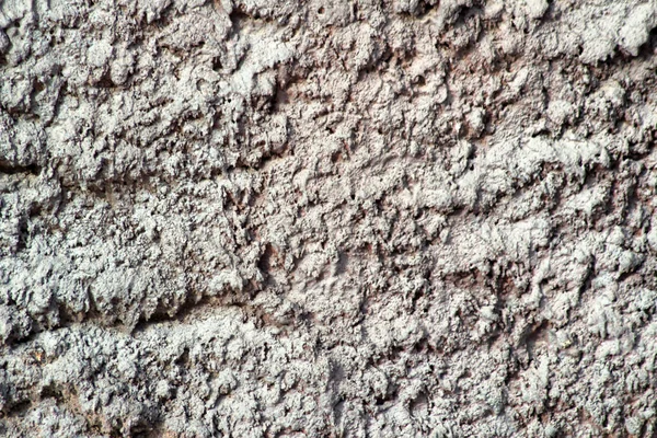 Fragment van een muur van een gechipte steen — Stockfoto