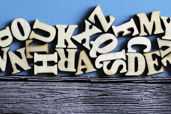 Lettres anglaises en bois en vrac et sur fond bleu en bois — Photo