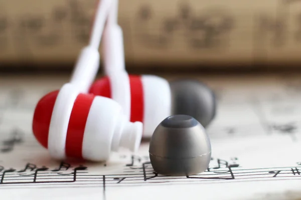 Headphones and a book with notes — Stock Photo, Image