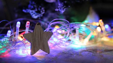 Tahta yıldız ve parlayan Noel ışıklarının bulanık görüntüsü