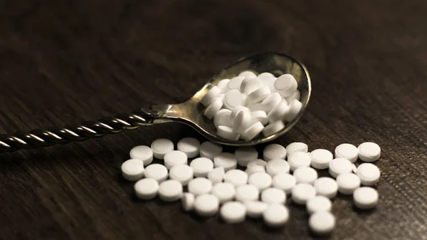 Diabetes concept. Sugar substitute tablets in a spoon.