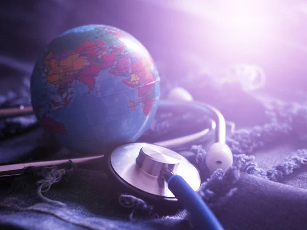 Stethoscope and globe, the blue color of the image. World medicine.