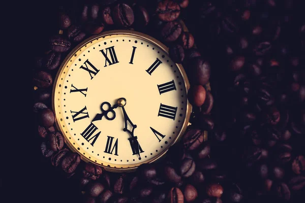 Antique clock with Roman numerals and coffee beans, top view