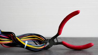 Elektrikçi kablolardan izolasyonu söküyor - ellere ve penseye yakın çekim