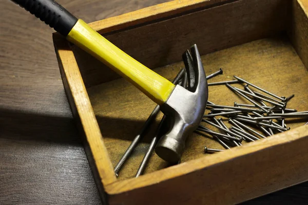 The yellow hammer and nails, tools for construction and repair, so close