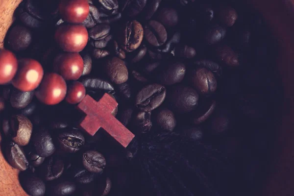 coffee beans and a wooden cross top view, vintage
