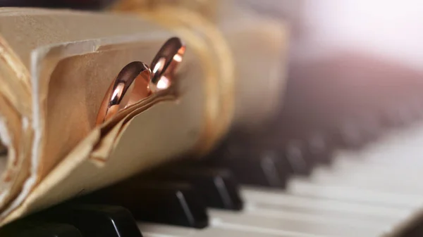 Két Arany Jegygyűrű Régi Hangjegyek Zongorakulcsok — Stock Fotó