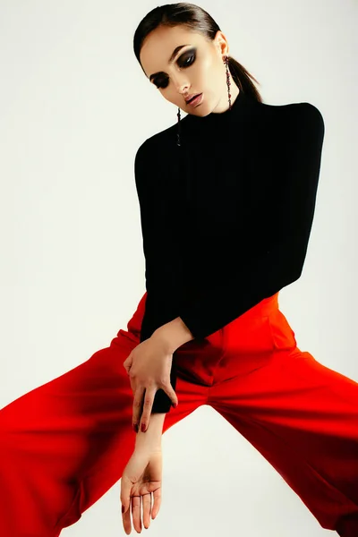 woman in black shirt and red pants