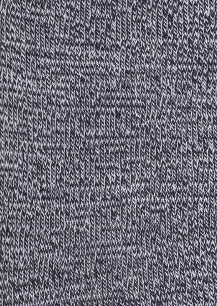 Warm black and white wool sweater texture. Knitted fabric background.