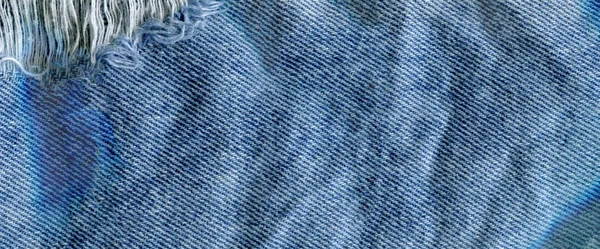 Blauw denim jean textuur achtergrond. Jeans gescheurd stof textuur — Stockfoto