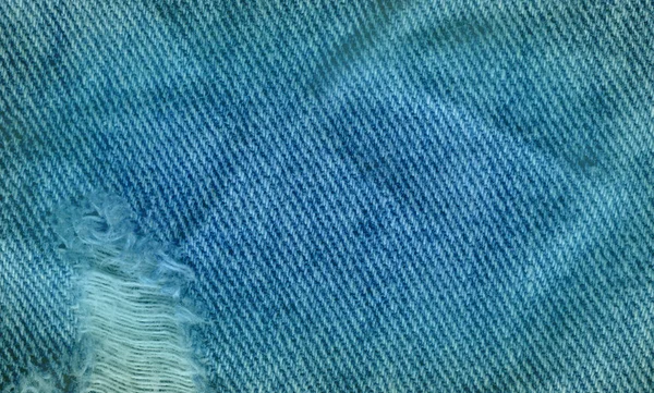 Vista close-up azul limpar textura denim. Azul rasgado jeans textura — Fotografia de Stock