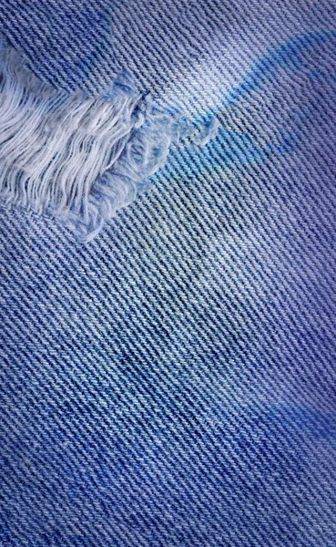 Modrá denim jean texturu pozadí. Džíny, roztrhané textilie textura — Stock fotografie