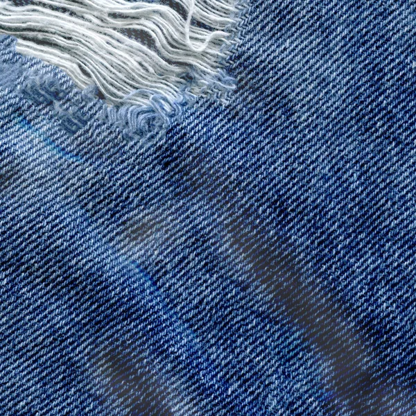 Modrá denim jean texturu pozadí. Džíny, roztrhané textilie textura — Stock fotografie