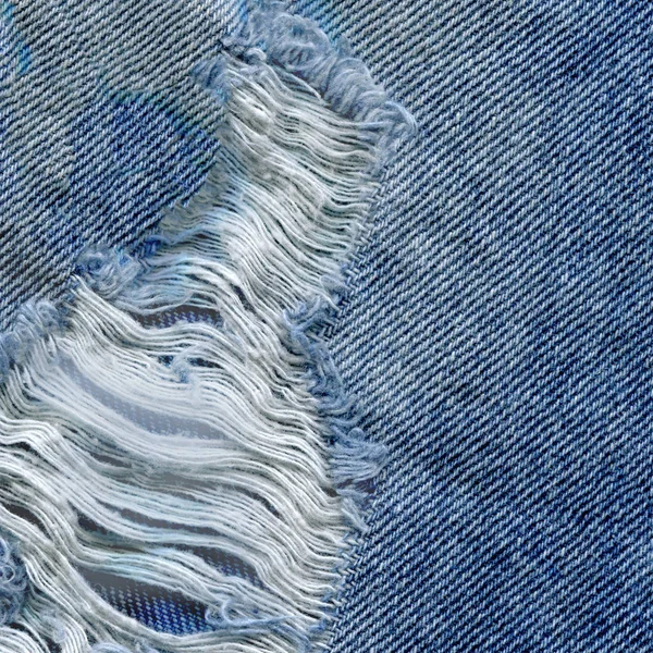 Modrá denim jean texturu pozadí. Džíny, roztrhané textilie textura — Stock fotografie