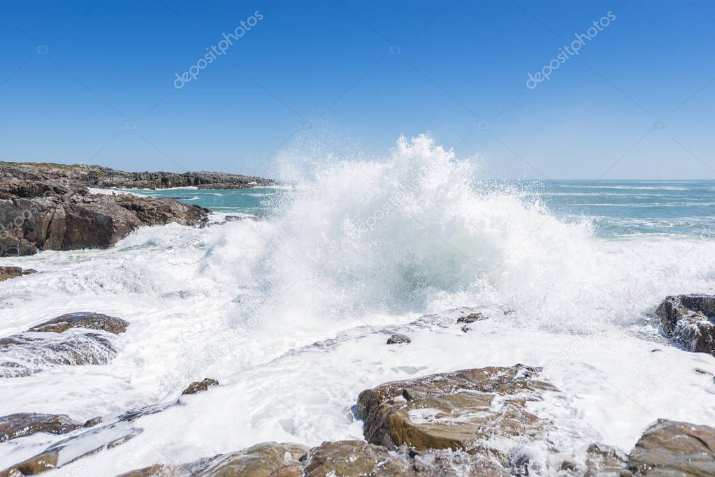 waves crashing over coastal rocks