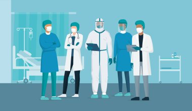 Profesyonel doktorlar ve hemşireler hastane koğuşunda birlikte poz veriyorlar ve koruyucu kıyafetler giyiyorlar. Virüs salgını acil durum kavramı.