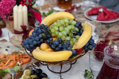 üzüm ve muz masada bir vazoda