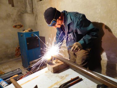 Kaynakçı metal bir yapı üzerinde çalışıyor.