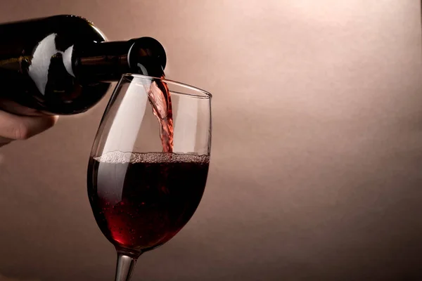 Copo de vinho sendo derramado de uma garrafa  . — Fotografia de Stock