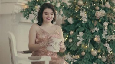 Kadın ve Noel ağacının yakınında hediye paketini açmalısınız