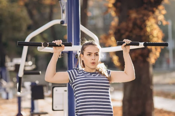 Güzel esmer kızın portresi terini alnından bir elle siliyor. Yoğun fitness egzersizinden sonra yoruldu. Yazın parkta motive olmuş genç bir kız, sağlıklı yaşam tarzı, spor anlayışı. — Stok fotoğraf