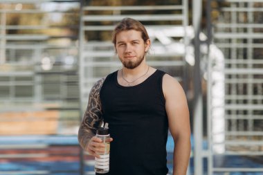 Spor shaker fitness eğitim sonrası yorgun sporcu adam içme suyu. Susuz adamın içki kokteyl spor şişe vücut geliştirme eğitimi sırasında