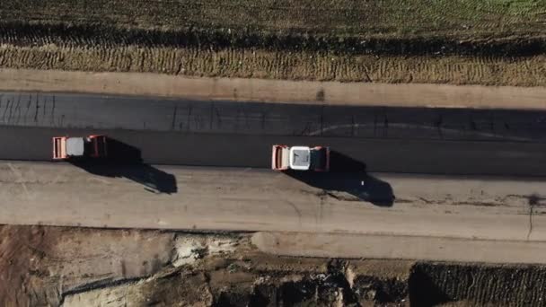 Aerial top view of roadworks with road roller doing road repair and paving of streets. Building s New Road with Road Repair. Road Construction and Repairing Works. — ストック動画